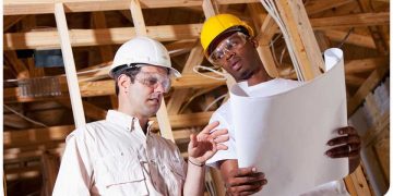 5280-1618204141-two-contractors-going-over-the-construction-plans-for-a-roof-replacement.jpg